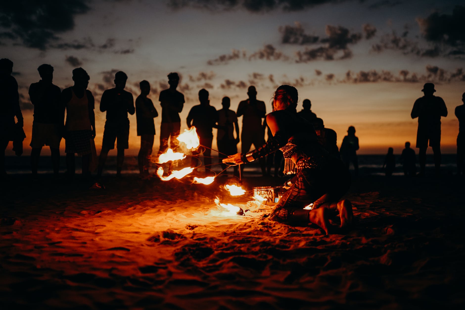 people standing on beach during sunset