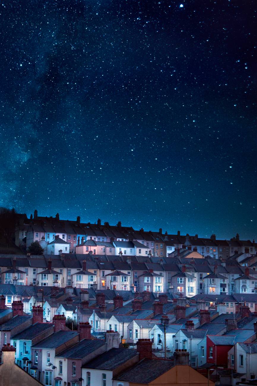 photo of houses under starry skies